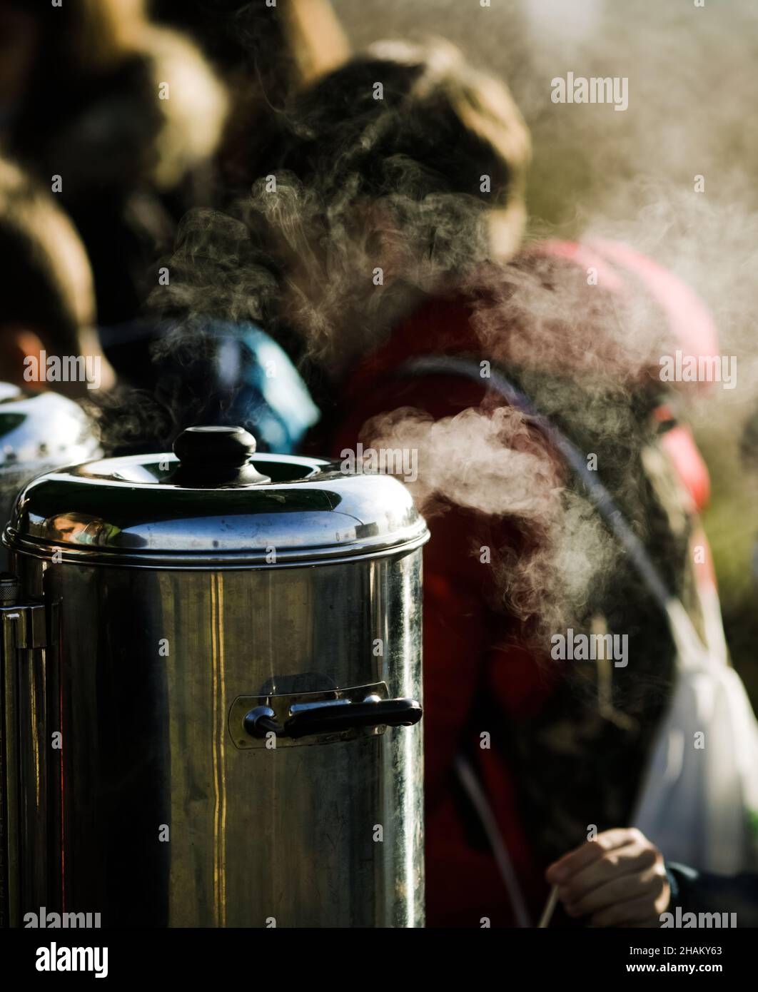 Shallow depth of field (selective focus) image with steam coming out from a portable water boiler for coffee and tea. Stock Photo