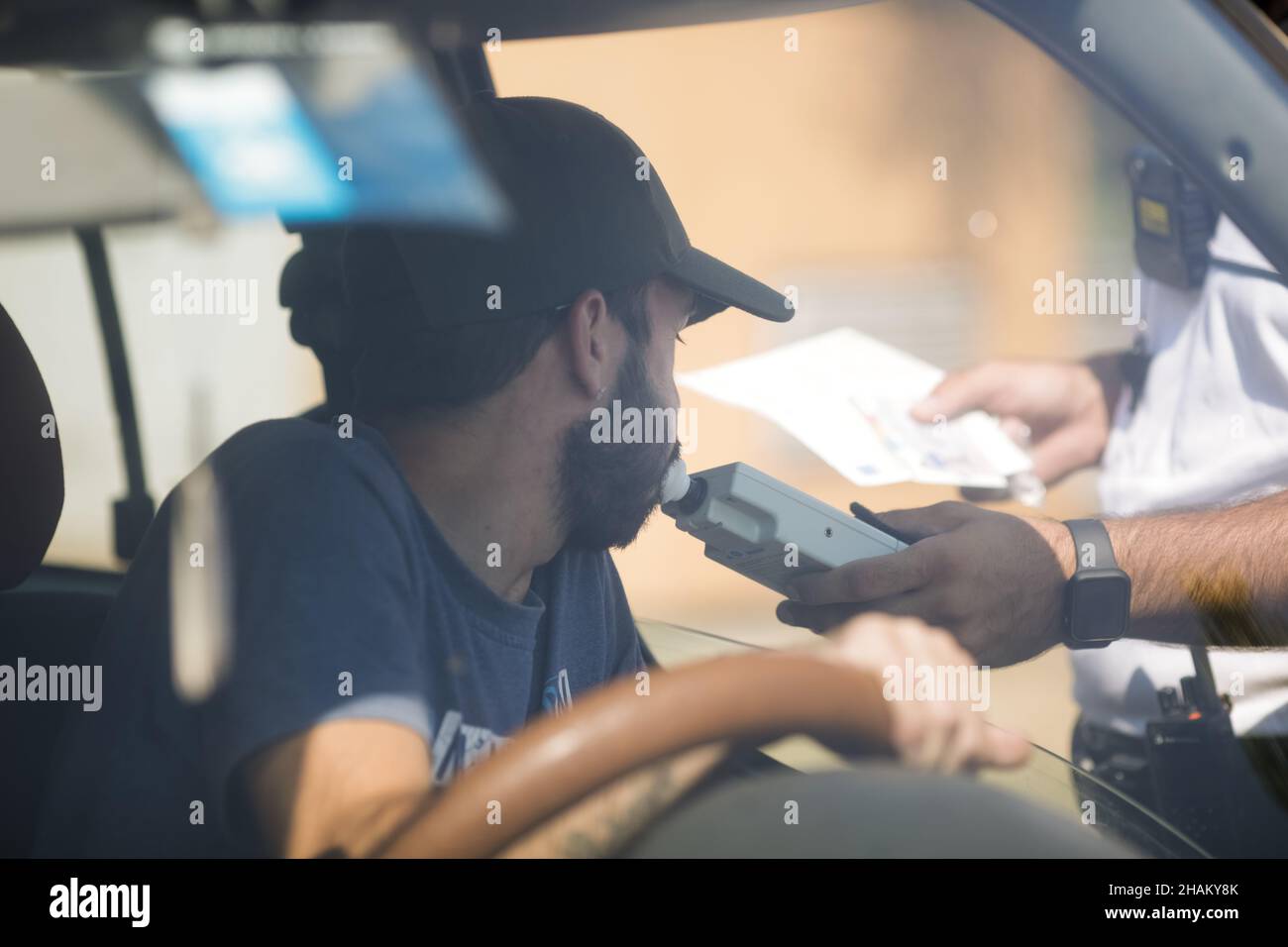 Highway 2 Bucharest - Constanta, Romania - 10 August, 2021: Romanian Road Police officer hands a breathalyser to a driver to test his alcohol level. Stock Photo