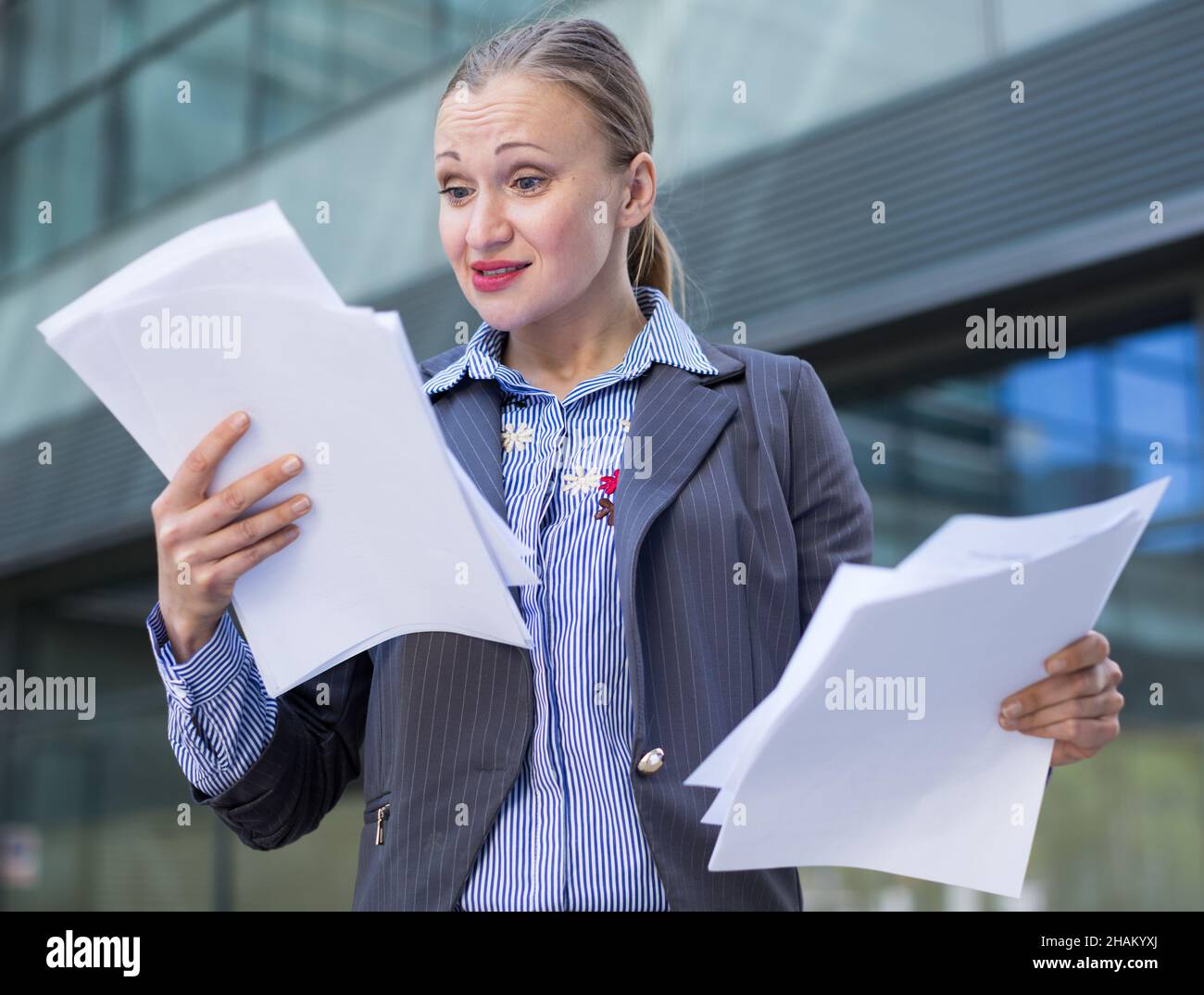 Professional woman in jacket working with documents Stock Photo