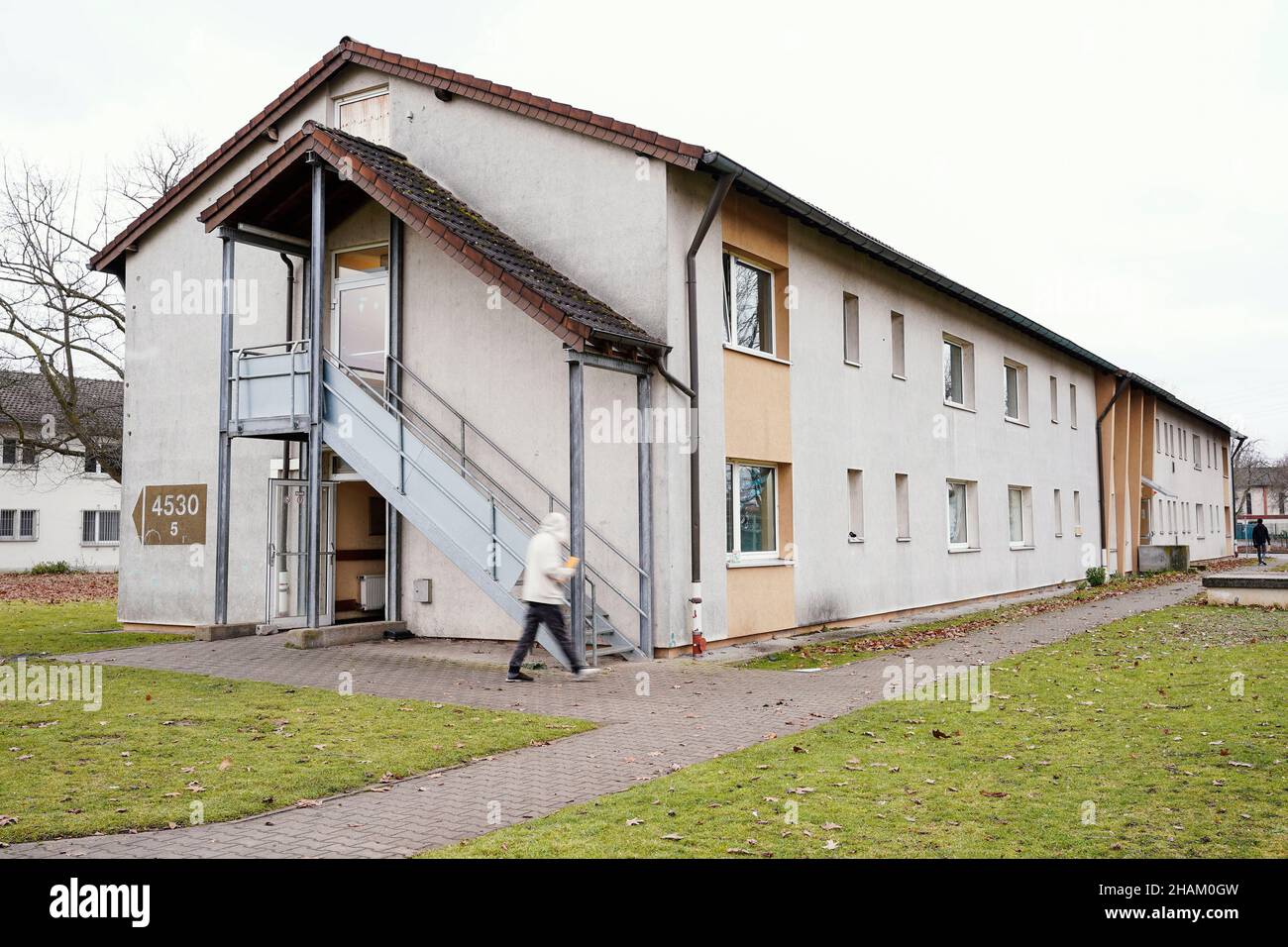 Heidelberg, Germany. 08th Dec, 2021. A resident walks past an apartment
