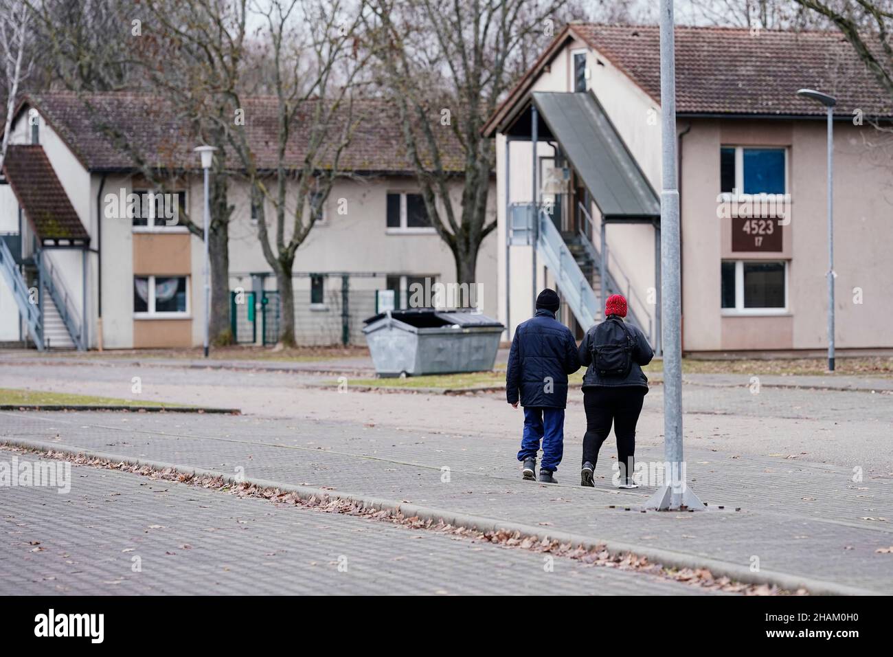 Heidelberg, Germany. 08th Dec, 2021. Residents walk past homes at the