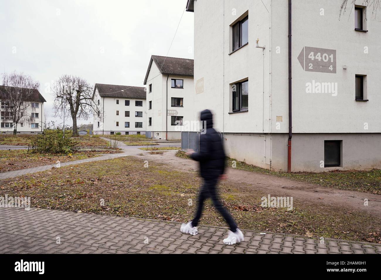 Heidelberg, Germany. 08th Dec, 2021. A resident walks past homes at the