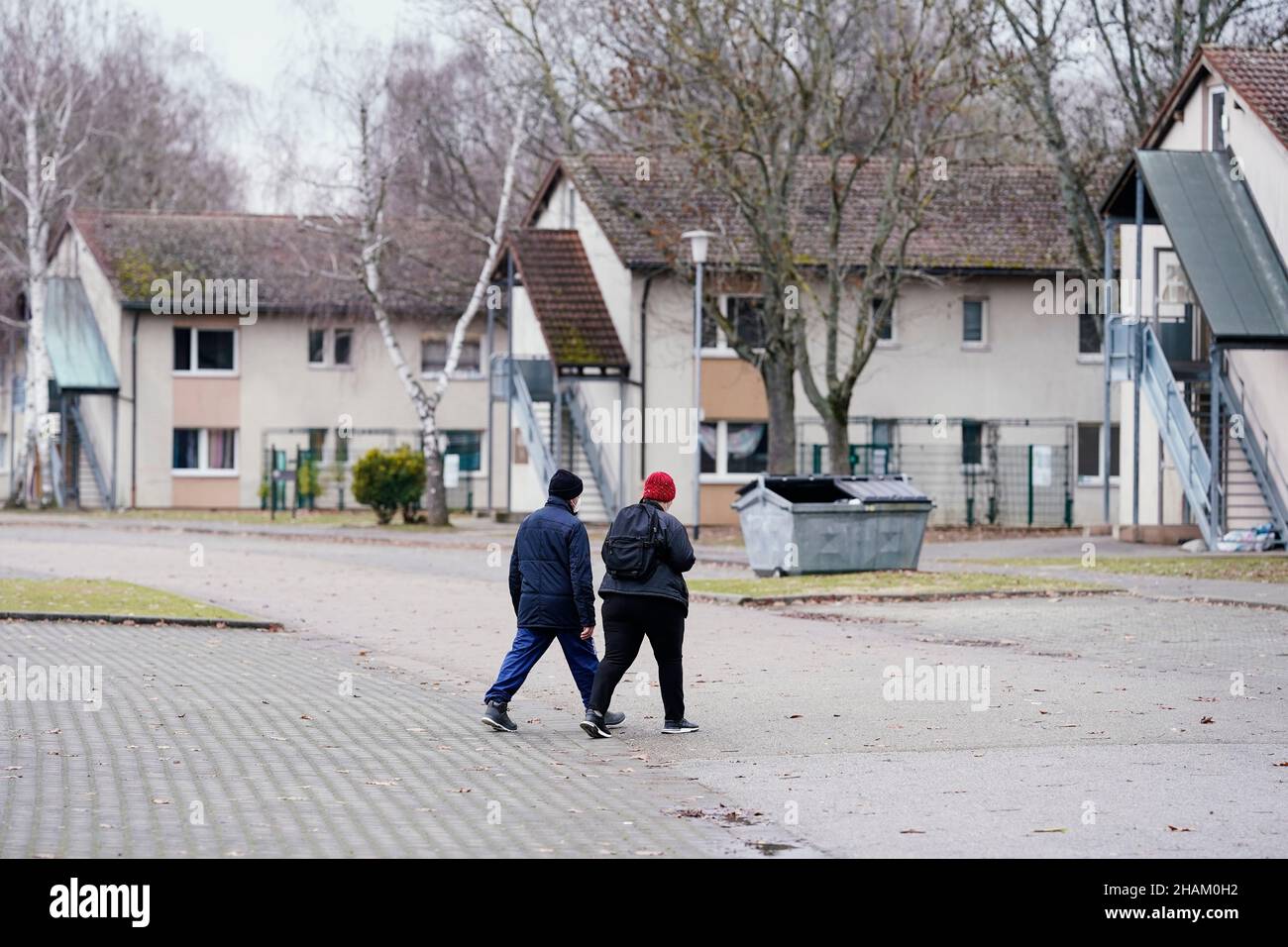 Heidelberg, Germany. 08th Dec, 2021. Residents walk past homes at the
