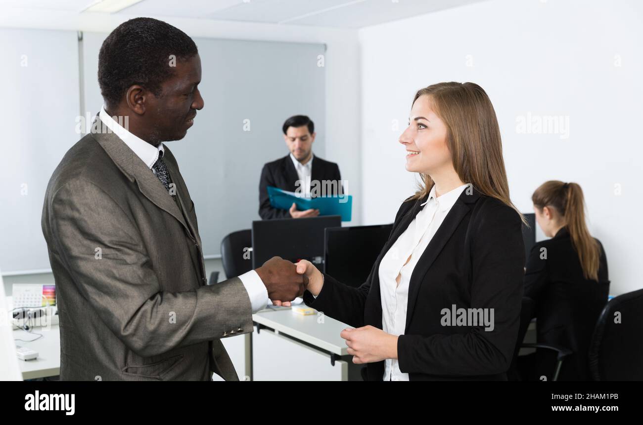 Businessman and businesswoman shaking hands Stock Photo - Alamy
