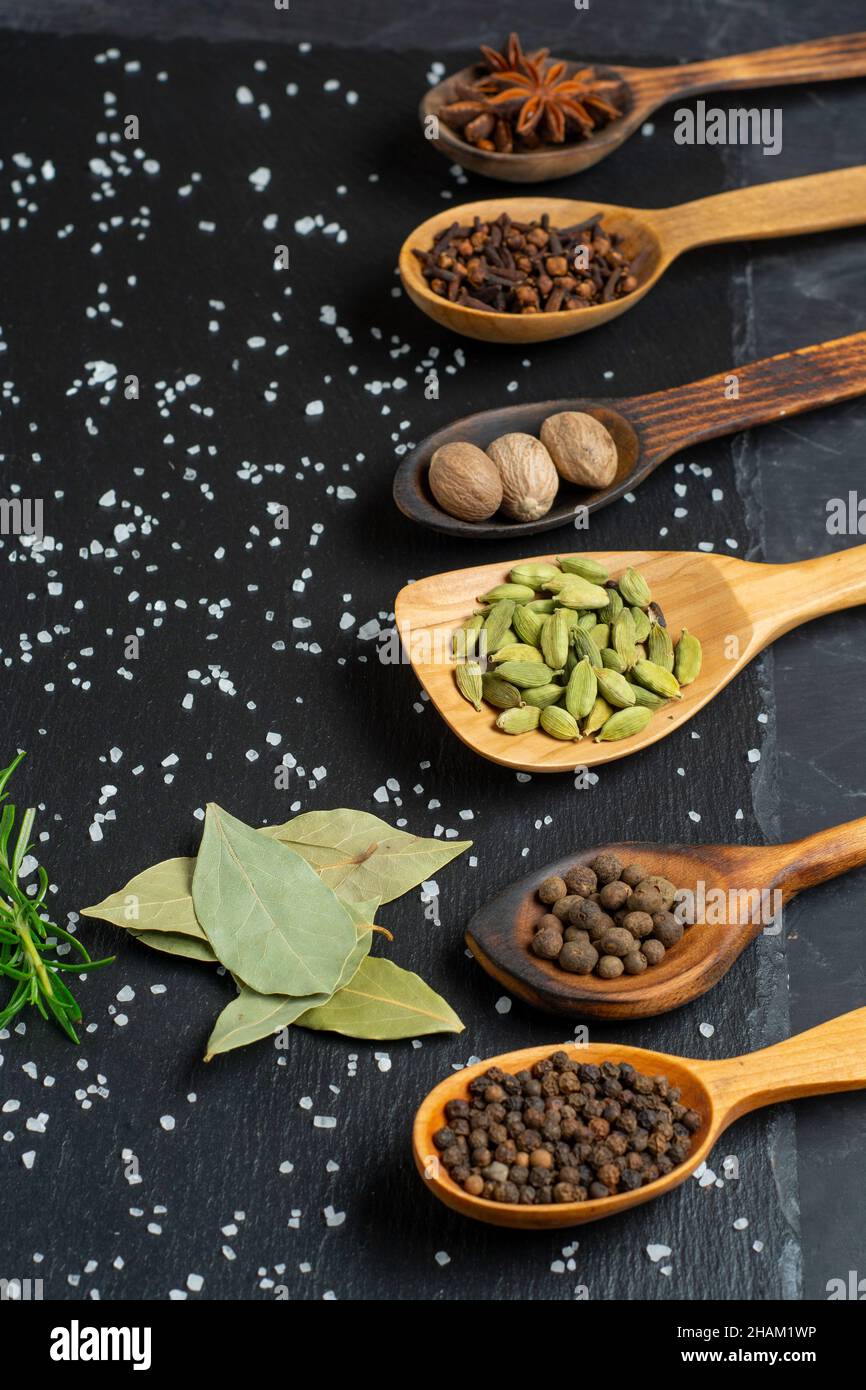Spices selection over dark wooden table. Food or spicy cooking concept, Healthy eating Background. Stock Photo