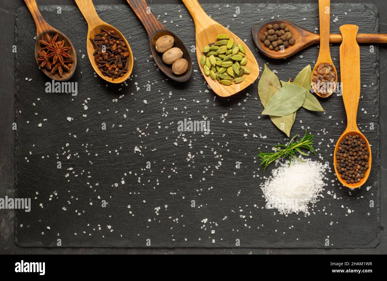 Spices selection over dark wooden table. Food or spicy cooking concept, Healthy eating Background. Stock Photo