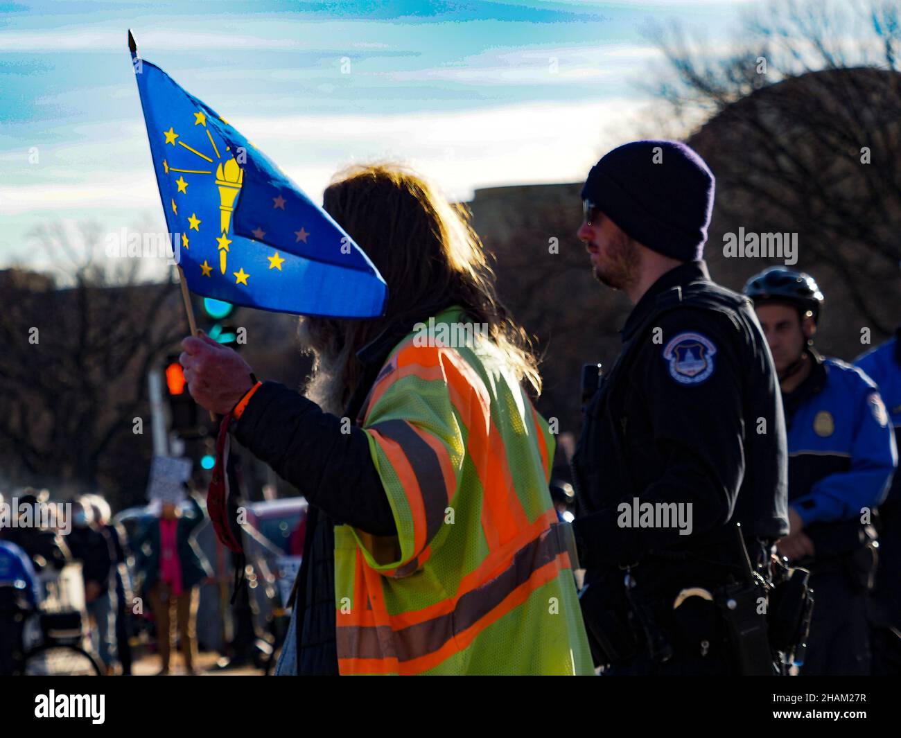 December 13, 2021, Washington, District of Columbia, USA: A man holding the Indiana state flag was one of several dozen arrested for civil disobedience following the Poor People CampaignÃs 'Get it Done in Ã21' rally at the US Capitol. Participants came from close to three dozen states to demand passage of stalled voting rights legislation and the Build Back Better plan before the end of December. (Credit Image: © Sue Dorfman/ZUMA Press Wire) Stock Photo