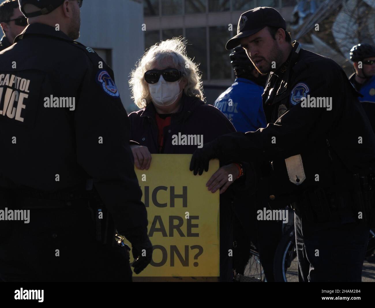 December 13, 2021, Washington, District of Columbia, USA: A woman holding a 'Which side are you on? Sen. Manchin' was one of several dozen arrested for civil disobedience following the Poor People CampaignÃs 'Get it Done in Ã21' rally at the US Capitol. Participants came from close to three dozen states to demand passage of stalled voting rights legislation and the Build Back Better plan before the end of December. (Credit Image: © Sue Dorfman/ZUMA Press Wire) Stock Photo