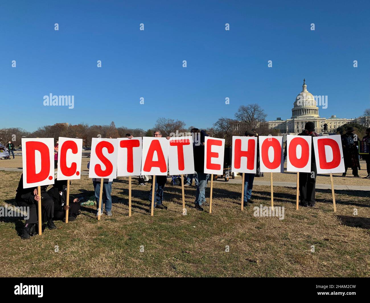 December 13, 2021, Washington, District of Columbia, USA: Some participants at the Poor Peoples CampaignÃs 'Get it done in 2021' rally held signs in support of DC statehood along with demands that Congress pass voting rights and the Build Back Better legislation before the end of the year. (Credit Image: © Sue Dorfman/ZUMA Press Wire) Stock Photo