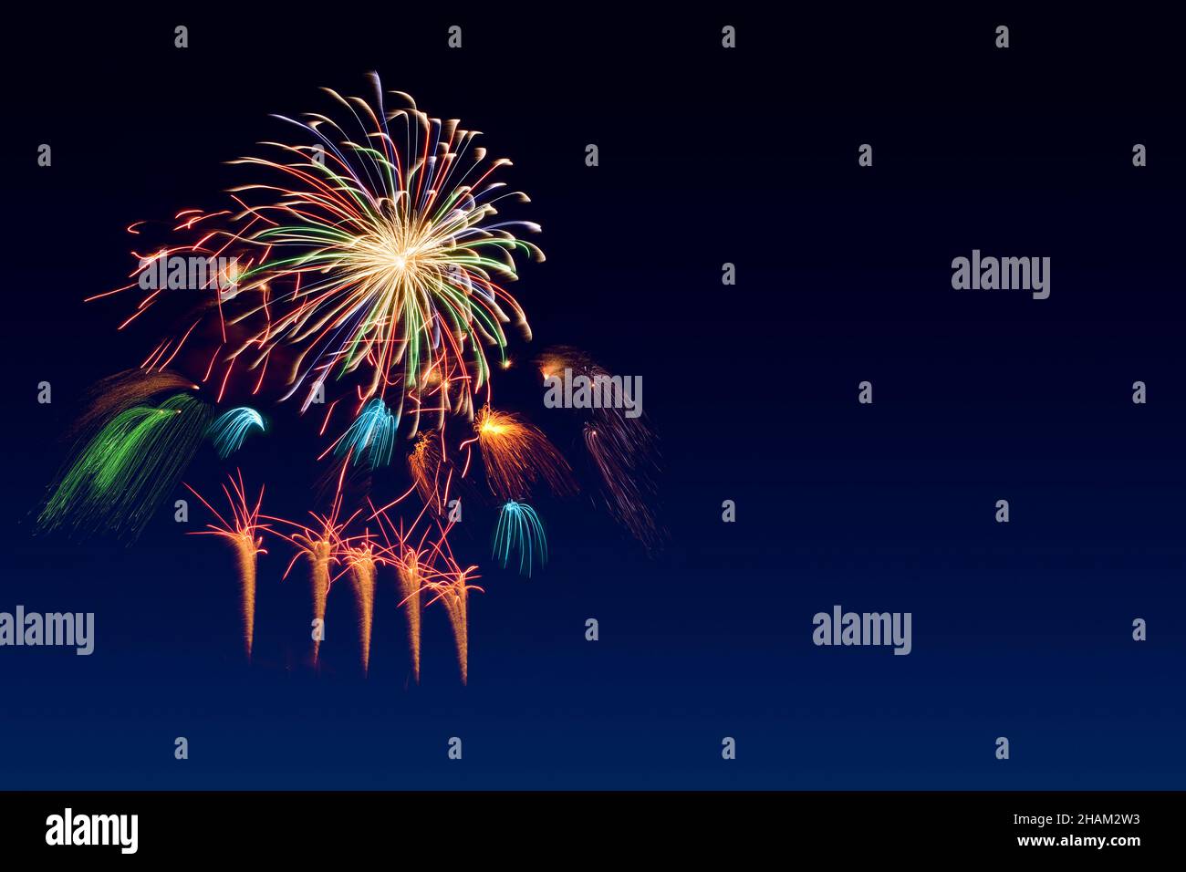 Colorful fireworks celebration and the twilight sky background with copyspace at the bottom of image. Stock Photo