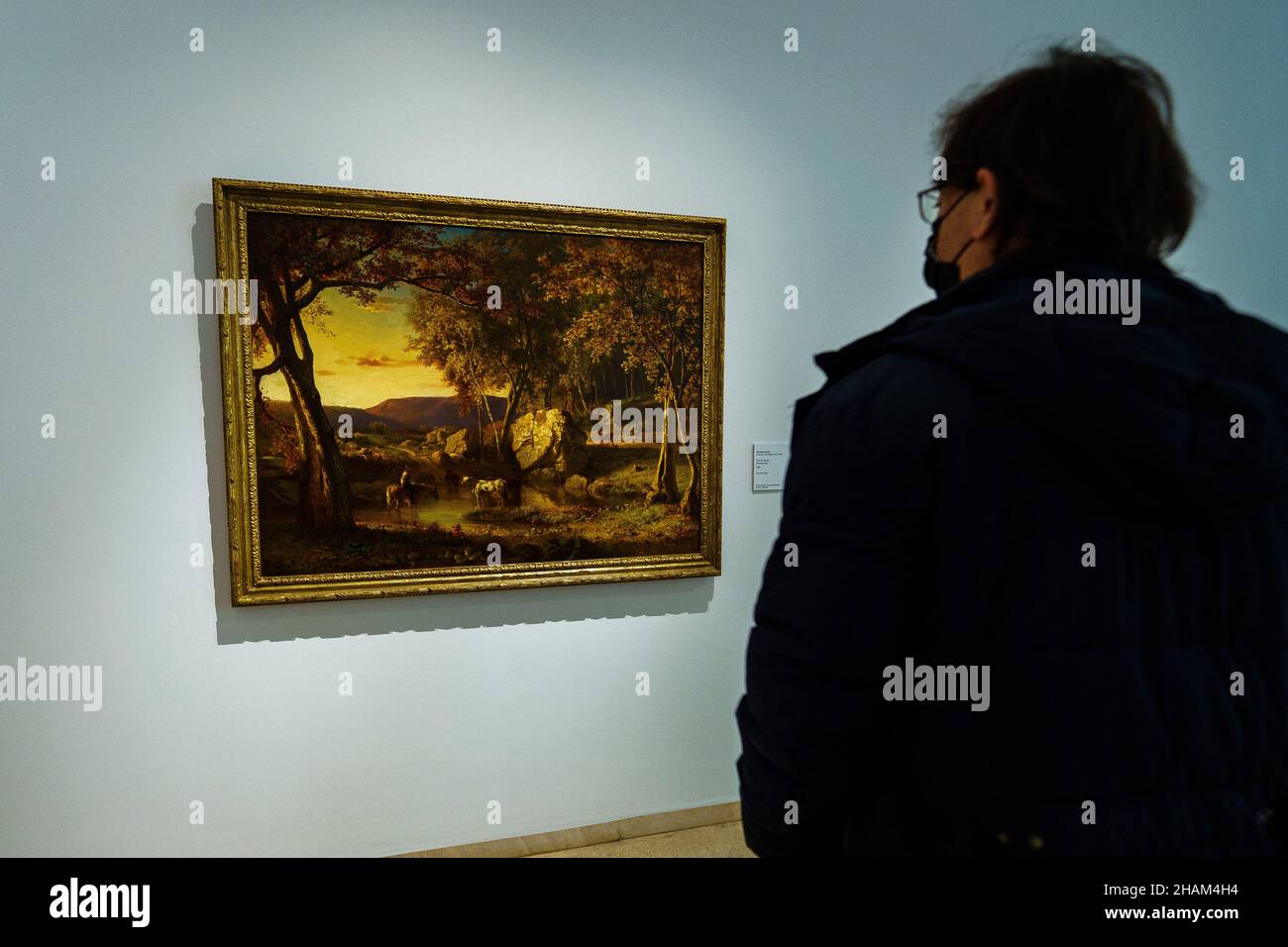 A visitor observes the artwork of the artist George Inness during the exhibition at the Museo Nacional Thyssen-Bornemisza in Madrid.The Museo Nacional Thyssen-Bornemisza presents an exhibition that brings together the magnificent collection of American art, the fruit of his collecting work for more than three decades. The works come with both the collections of the Thyssen family and Carmen Thyssen-Bornemisza and, mainly, from the museum itself, an exceptional set in the European context that has made the Thyssen Museum in Madrid an essential point of reference for the knowledge of the America Stock Photo