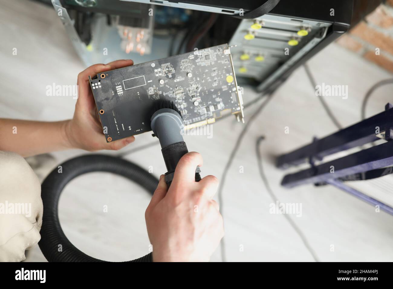 Man mechanic clean computer processor detail with vacuum cleaner nozzle Stock Photo