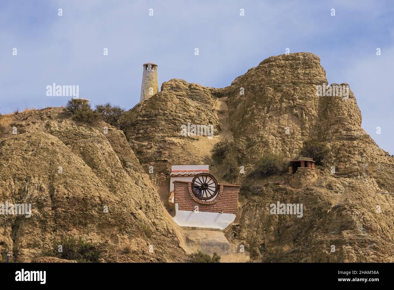 Balcony of a troglodyte habitations against a hill in Guadix Stock Photo
