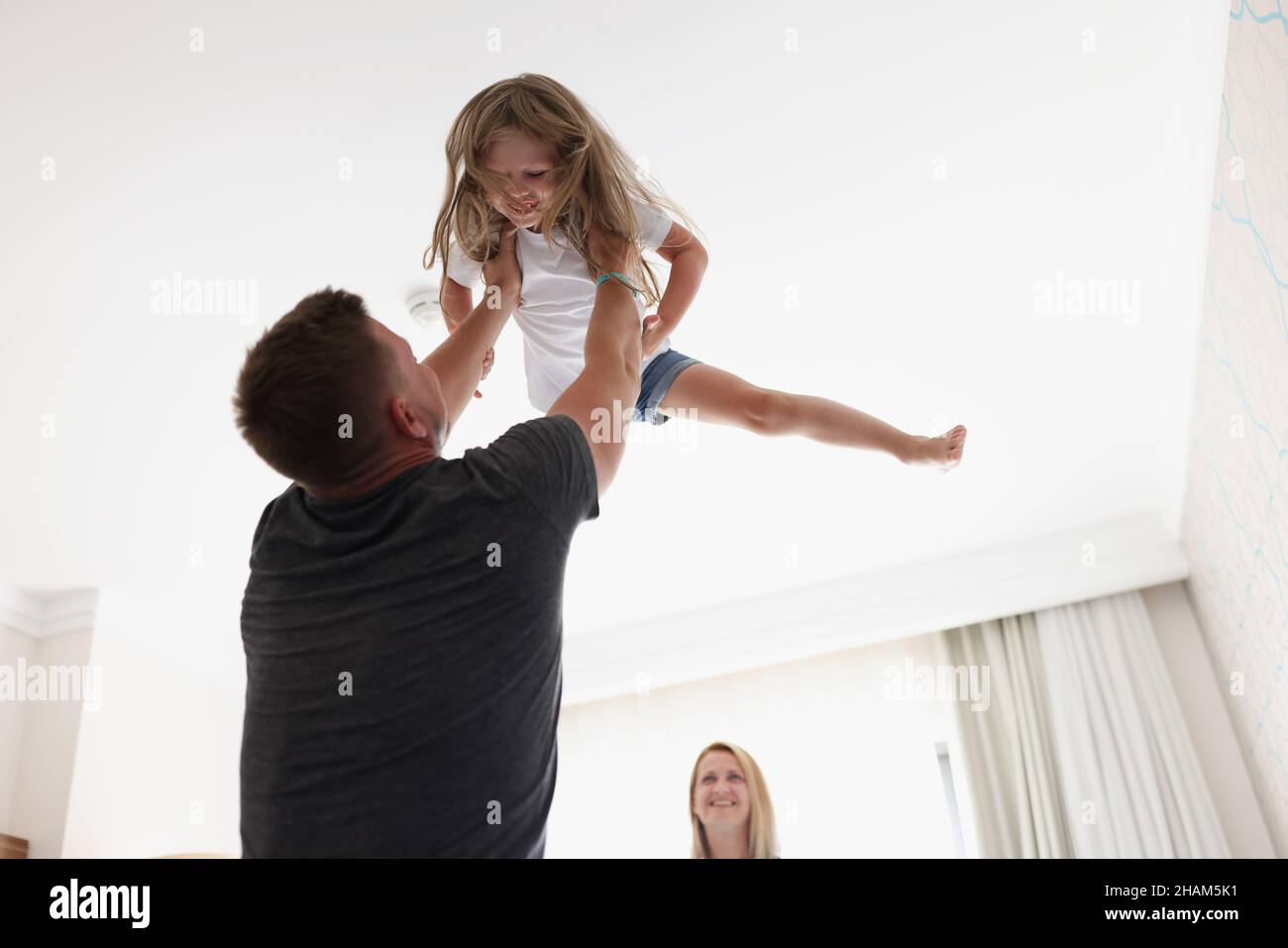 Father throws child in air and play with kid after work Stock Photo Alamy