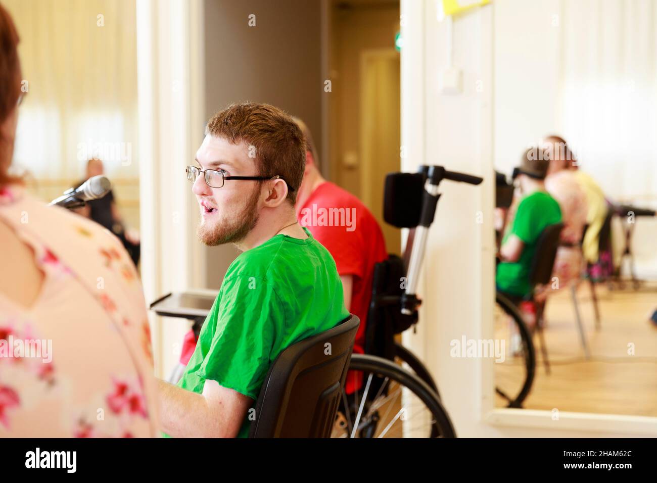 Disabled young man speaking to microphone Stock Photo Alamy