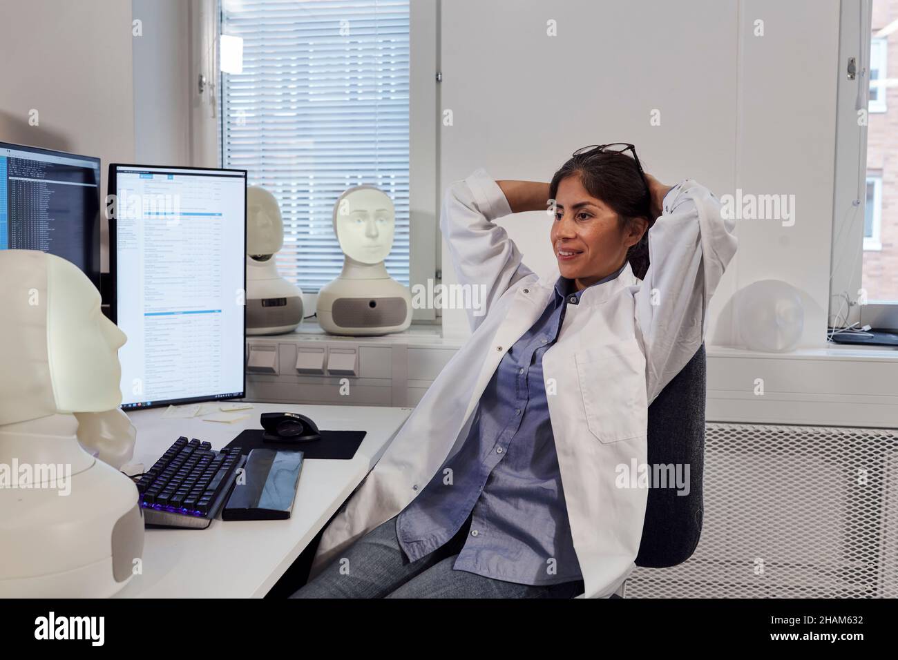 Female engineer sitting at work station Stock Photo