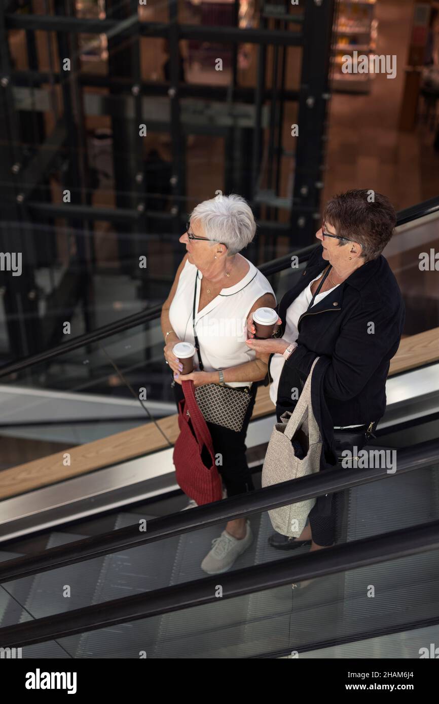Women on escalator, high angle view Stock Photo