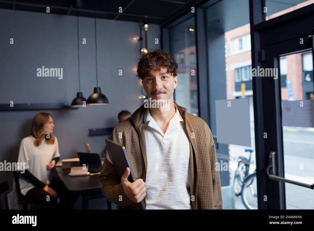 Smiling man in office looking at camera Stock Photo
