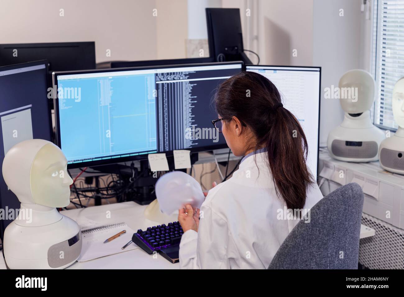 Female engineer working on robots Stock Photo