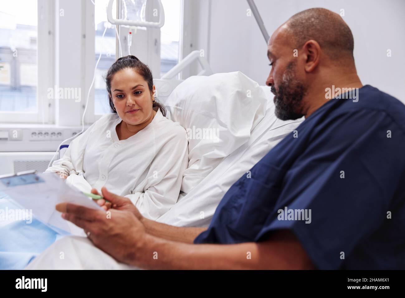 Female patient talking to nurse Stock Photo - Alamy