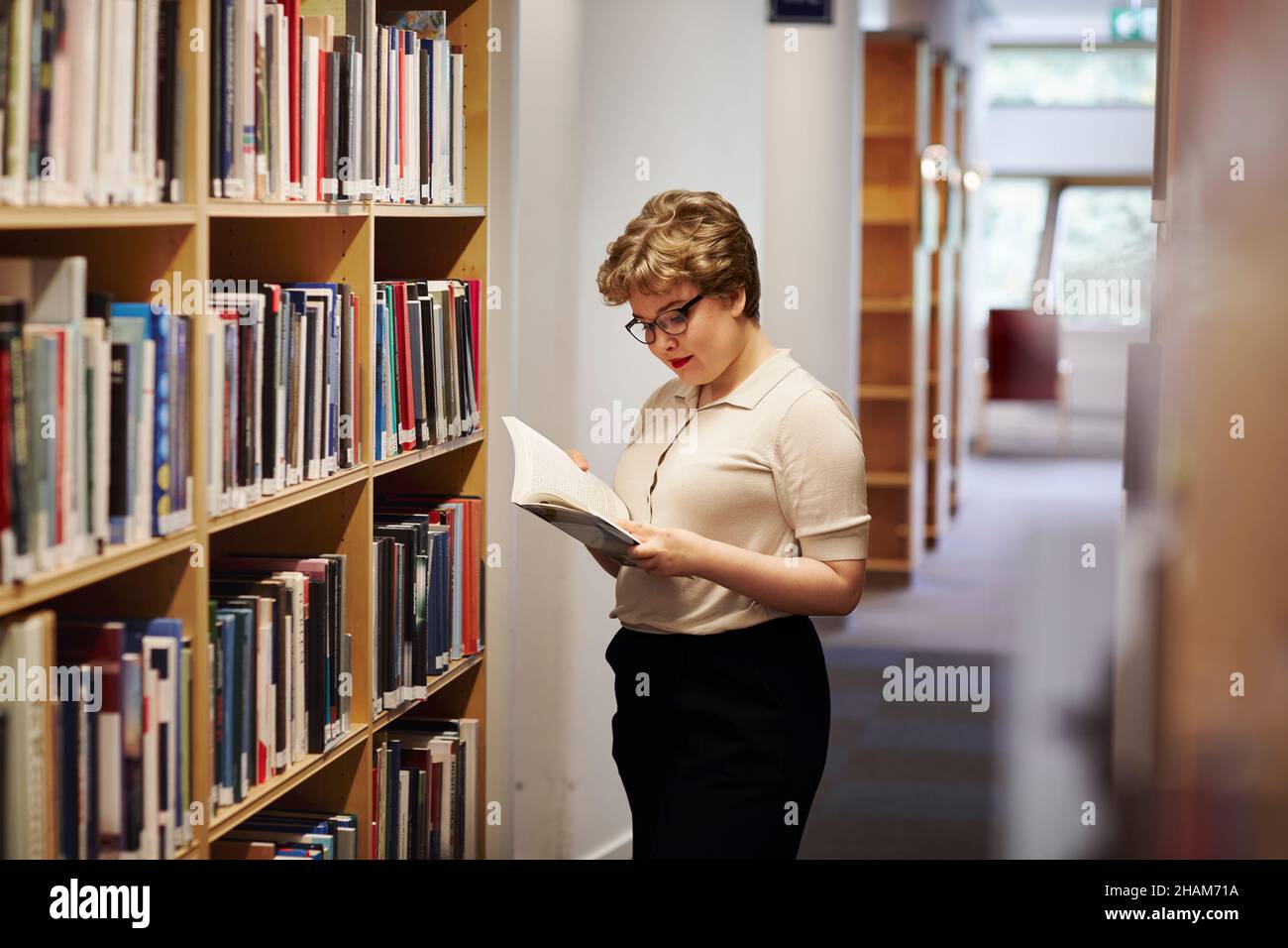 Young female student in library Stock Photo