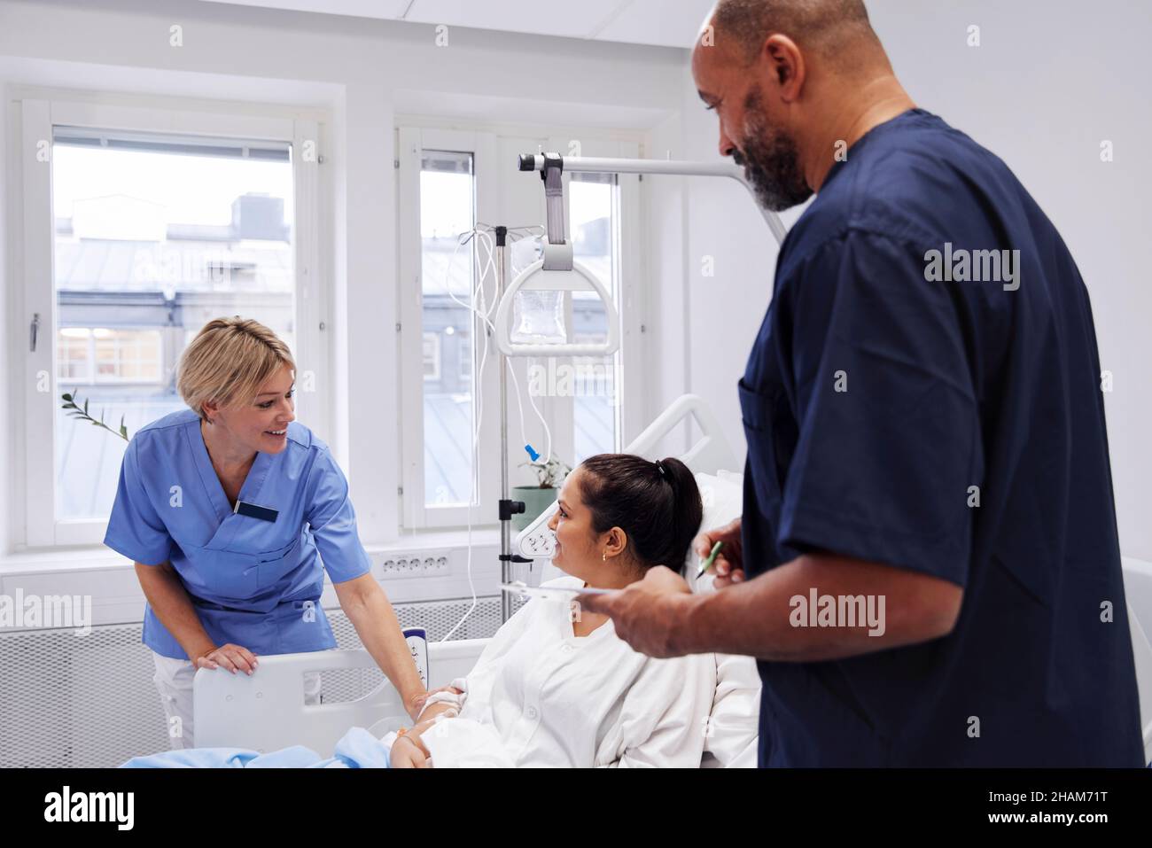 Female patient talking to nurse Stock Photo - Alamy