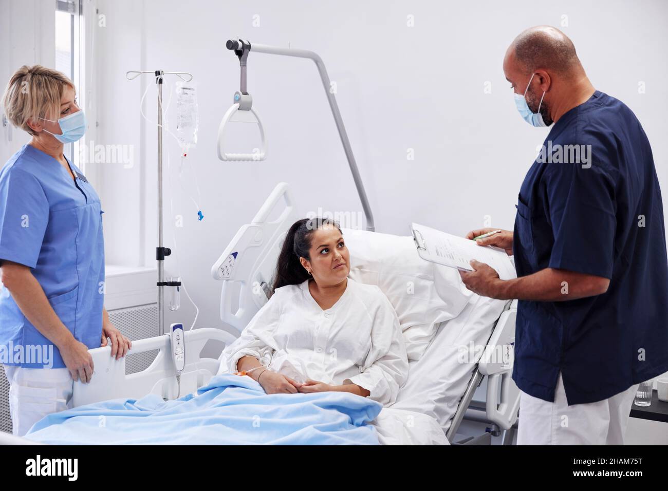 Female patient on hospital bed talking to nurse Stock Photo - Alamy