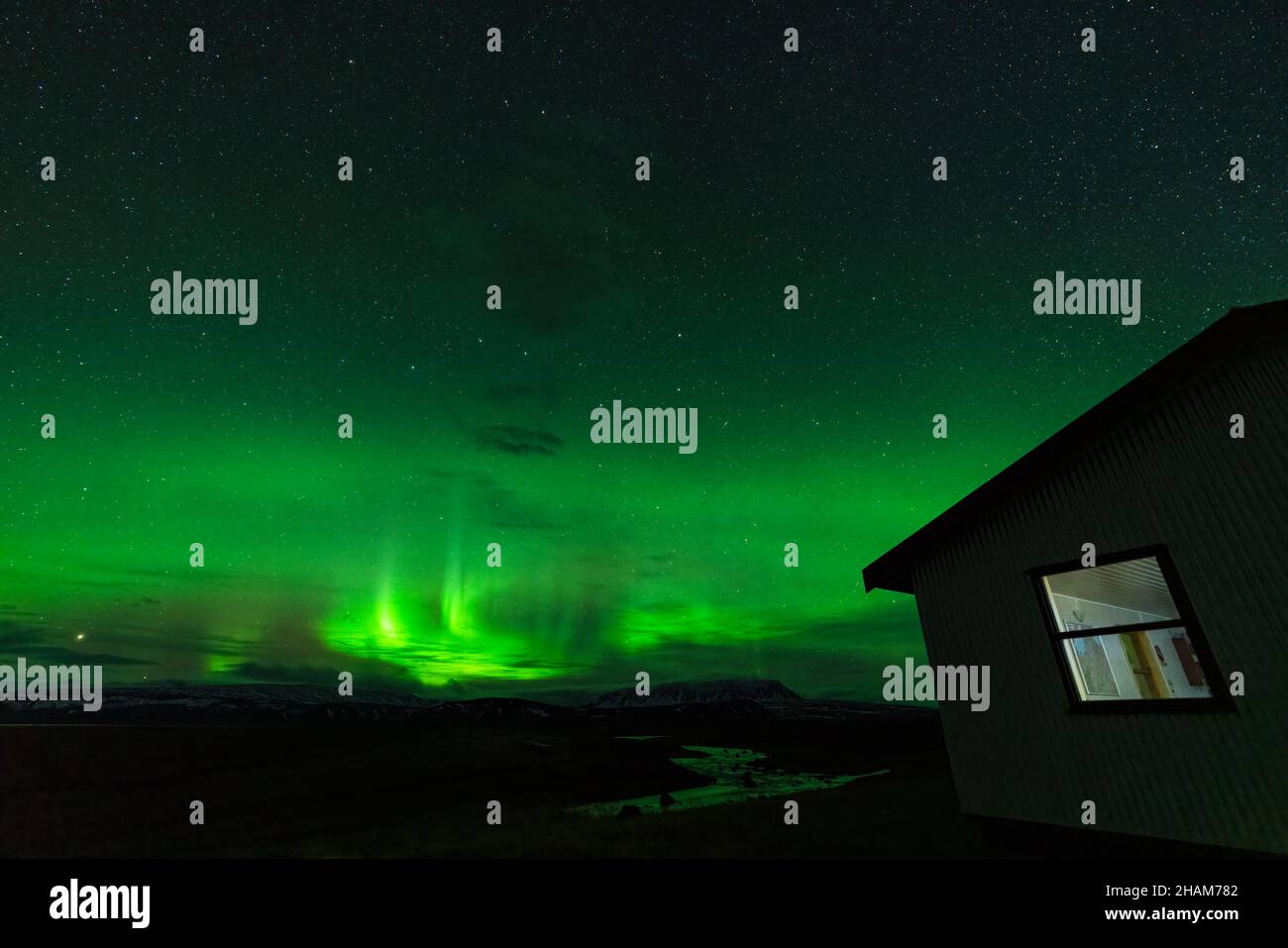 Aurora borealis lights with river and house Stock Photo