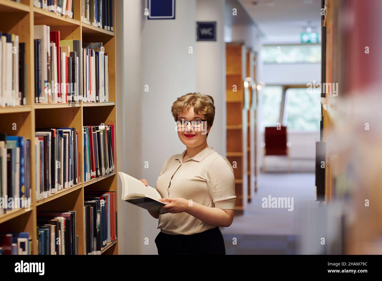 Young female student in library Stock Photo