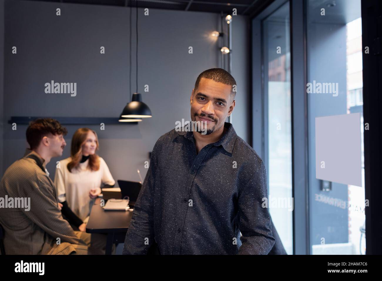 Smiling man in office looking at camera Stock Photo