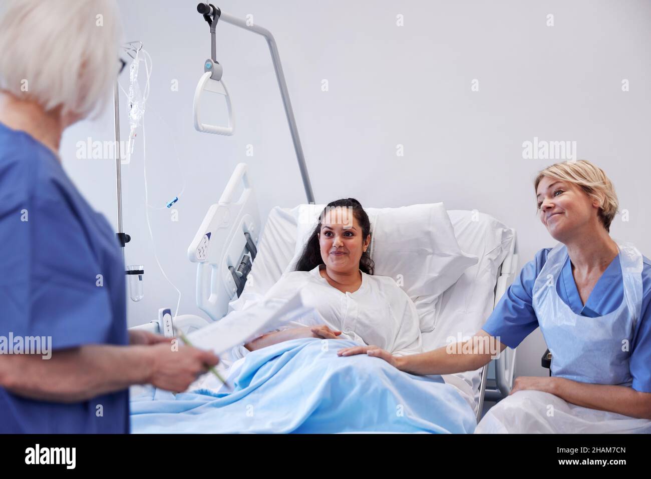 Female patient on hospital bed talking to nurse Stock Photo - Alamy