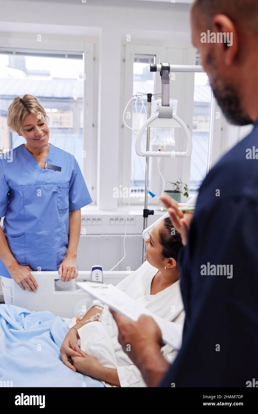 Female patient talking to nurse Stock Photo - Alamy