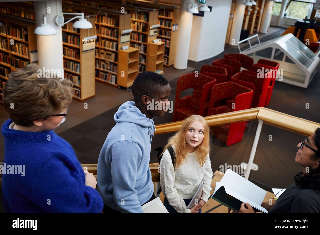 Group of students in library Stock Photo - Alamy