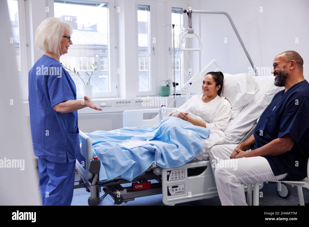 Female patient on hospital bed talking to nurse Stock Photo - Alamy