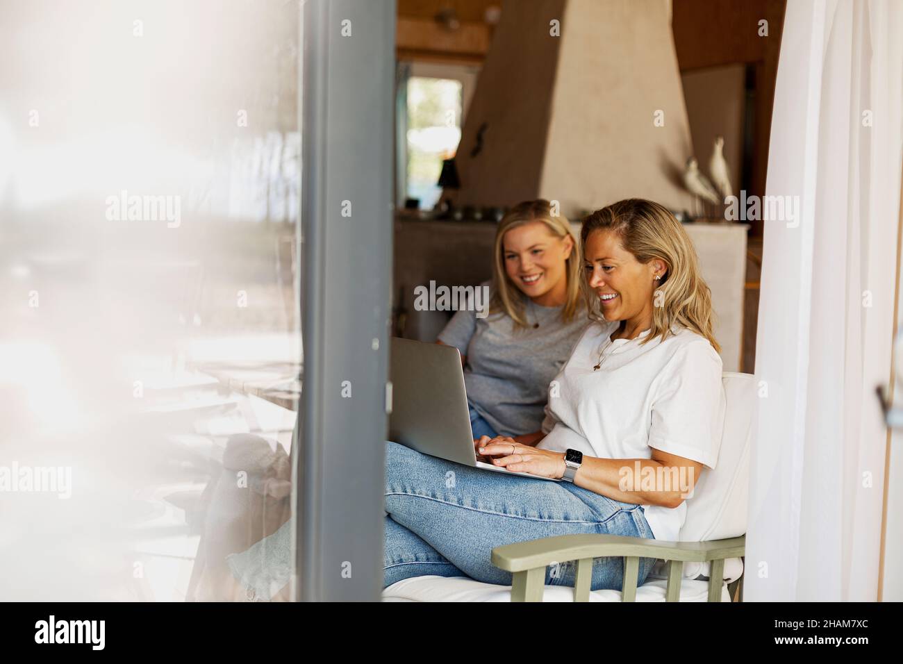 Smiling women using laptop Stock Photo