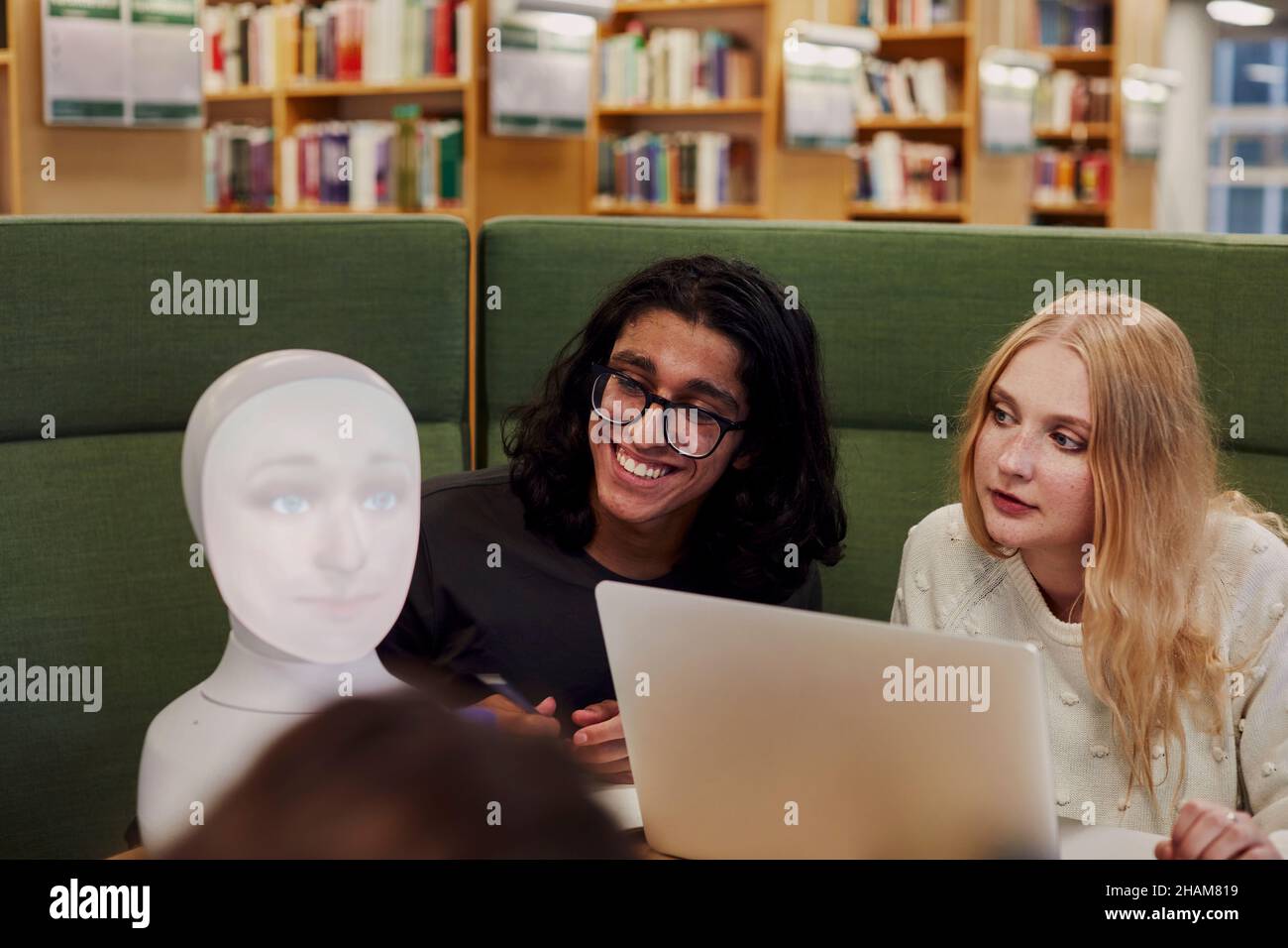 Smiling Friends Library Friends sitting together in library Stock Photo - Alamy