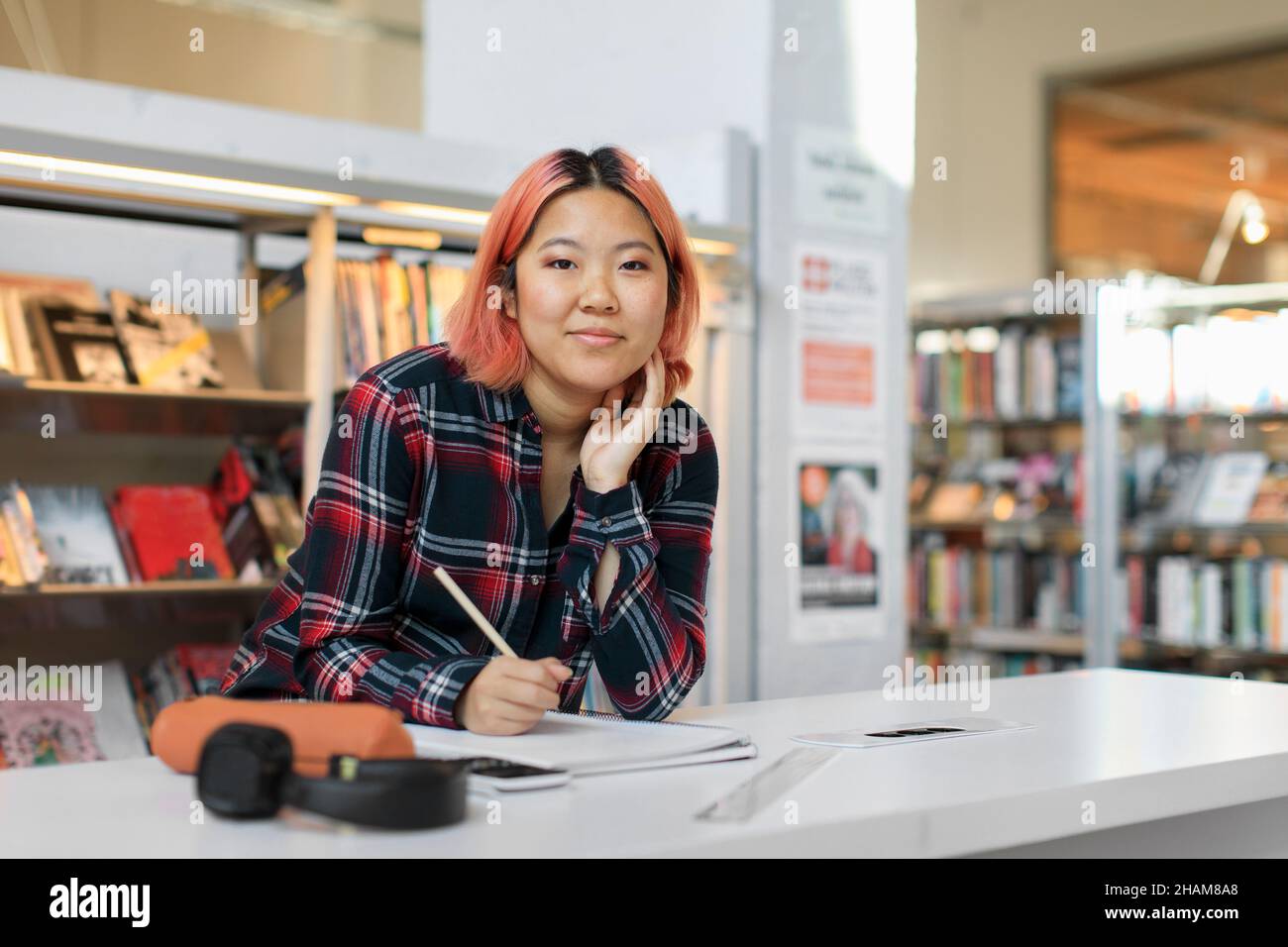 Young woman studying in library Stock Photo