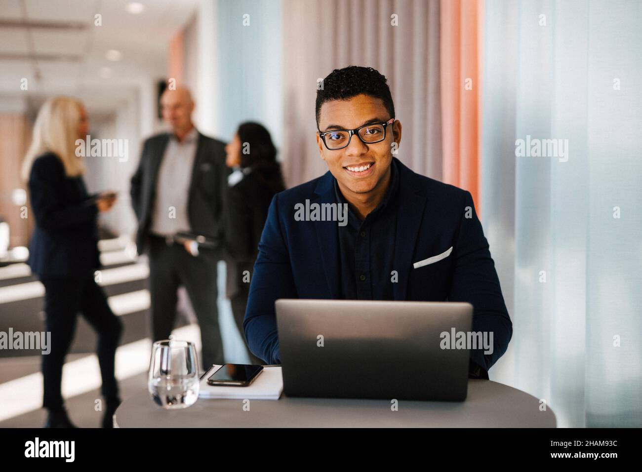Man with laptop sitting in office Stock Photo