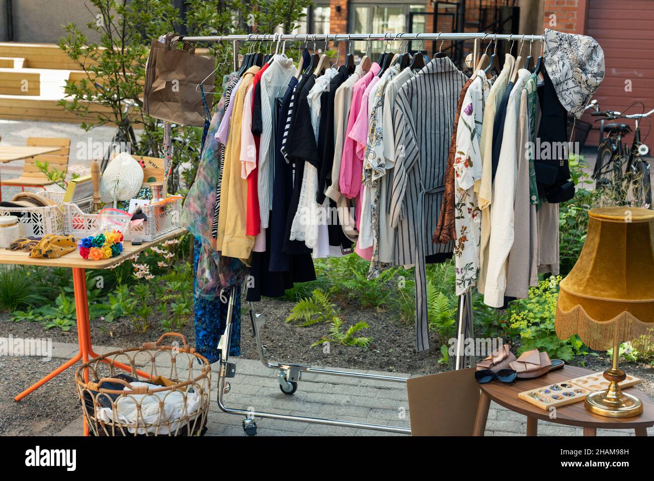 Clothes in rack at yard sale Stock Photo Alamy