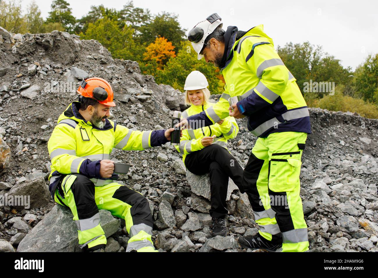 Engineers in reflective clothing having hot drink Stock Photo