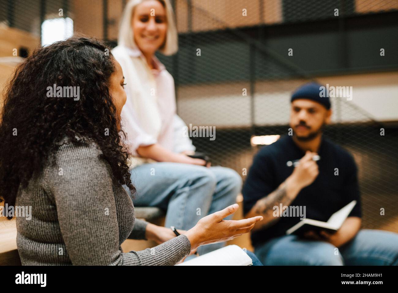 Coworkers talking at corridor Stock Photo
