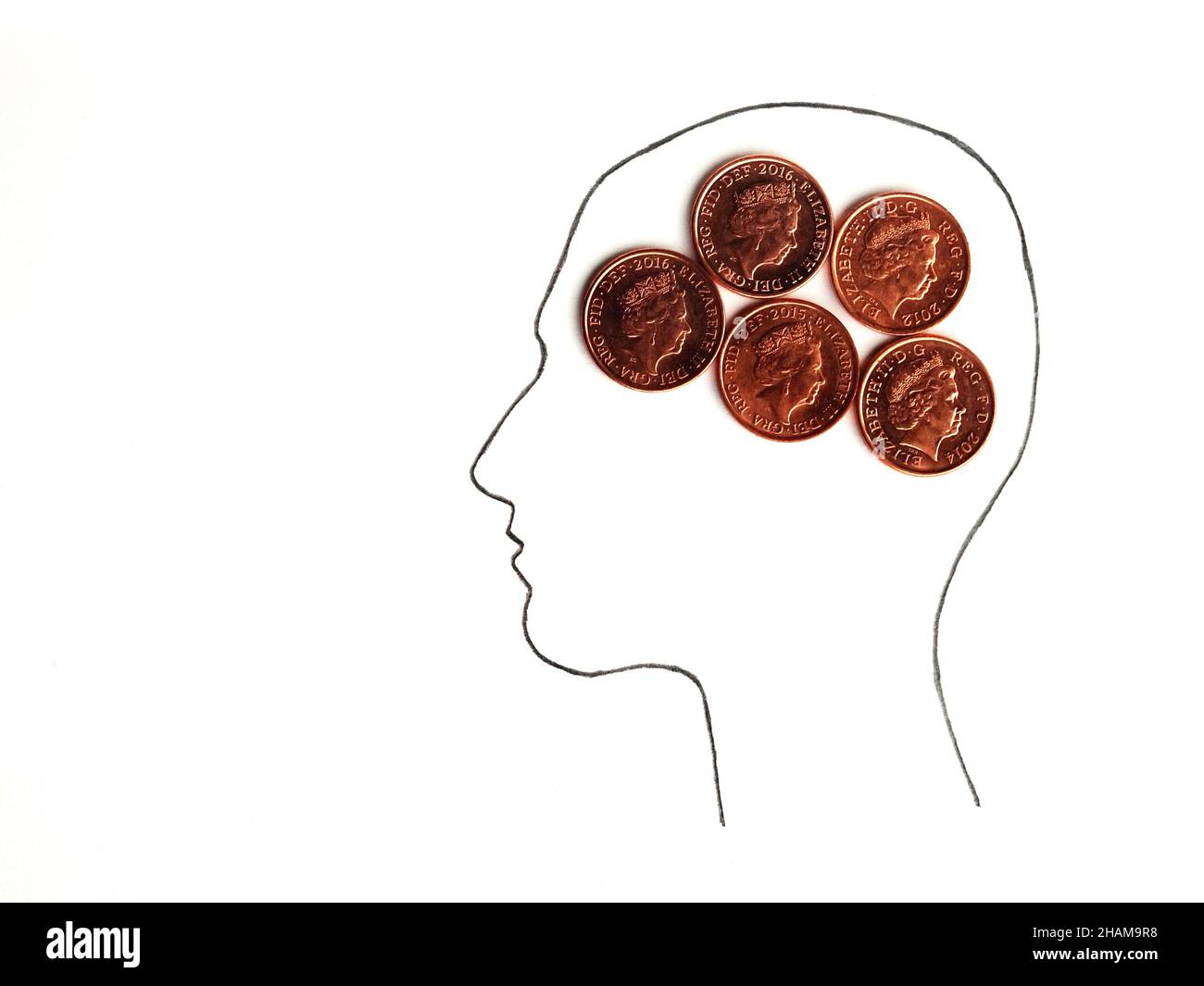 Head silhouette with one pence coins instead of the brain isolated on white background Stock Photo