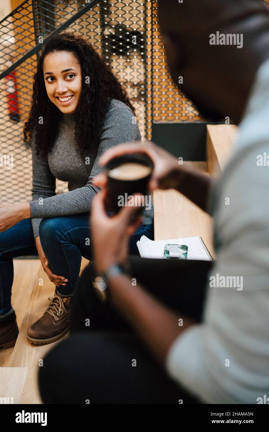 Smiling woman talking to man Stock Photo