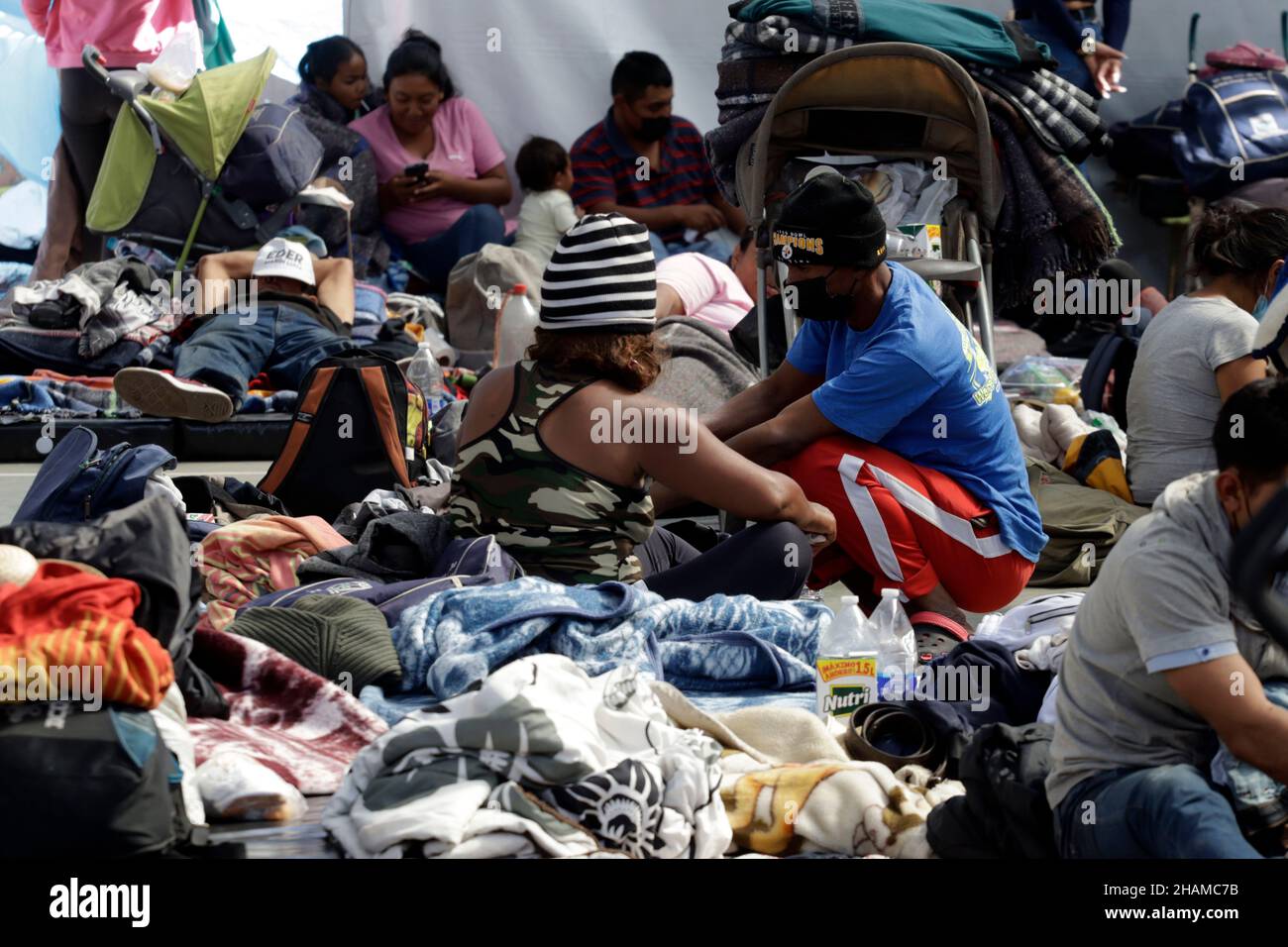 Non Exclusive: MEXICO CITY, MEXICO - DECEMBER 13, 2021: Migrants rest during their stay at Casa del Peregrino San Juan Diego before continue their jou Stock Photo
