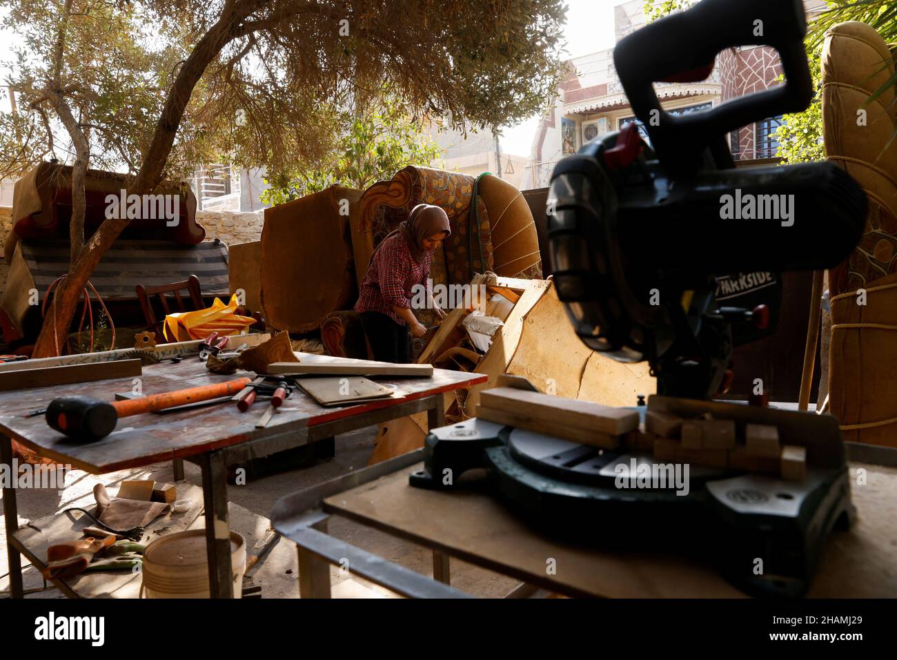 Noor Al-Janabi, 28, an Iraqi woman carpenter, repairs a furniture piece in the garage of her home in Baghdad, Iraq December 6, 2021. Picture taken December 6, 2021. REUTERS/Saba Kareem Stock Photo