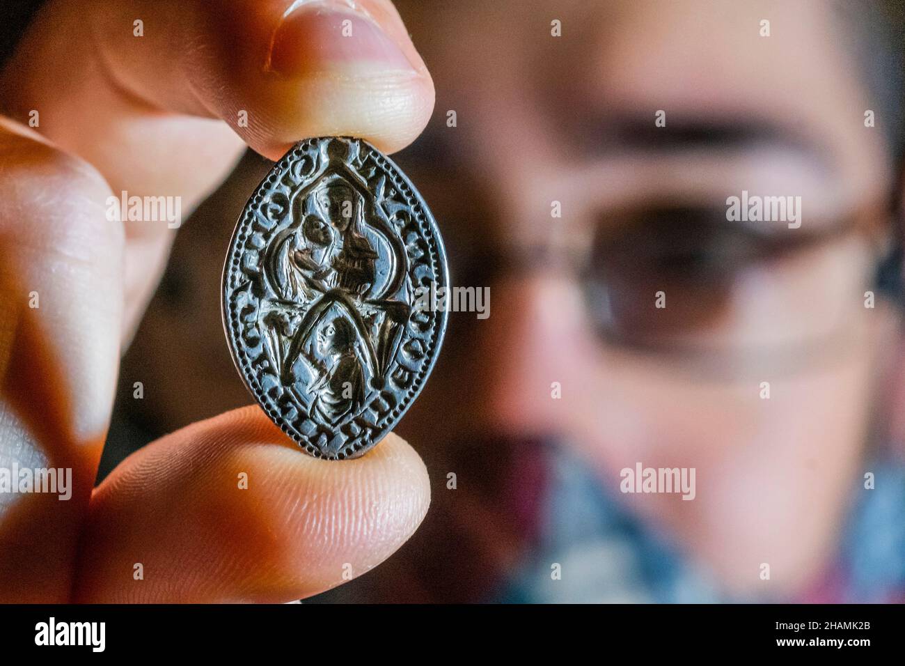 London, UK. 14th Dec, 2021. A silver medieval seal matrix that uncommonly depicts a high-status woman, AD 1200-1300 found in Kent - A first look at recent archaeological discoveries made by members of the public, which are being announced for the first time at the British Museum. These finds are recorded under the British Museum's Portable Antiquities Scheme (PAS) and Treasure annual reports. Credit: Guy Bell/Alamy Live News Stock Photo