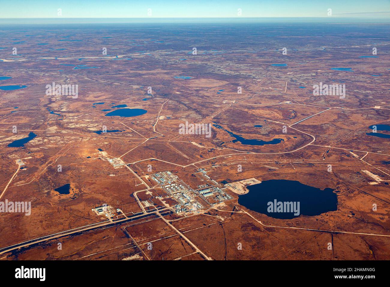 Aerial view of Siberian tundra in autumn. Oilfield in Yamal marshes. Extensive gas producing province in Western Siberia, Russia. Stock Photo