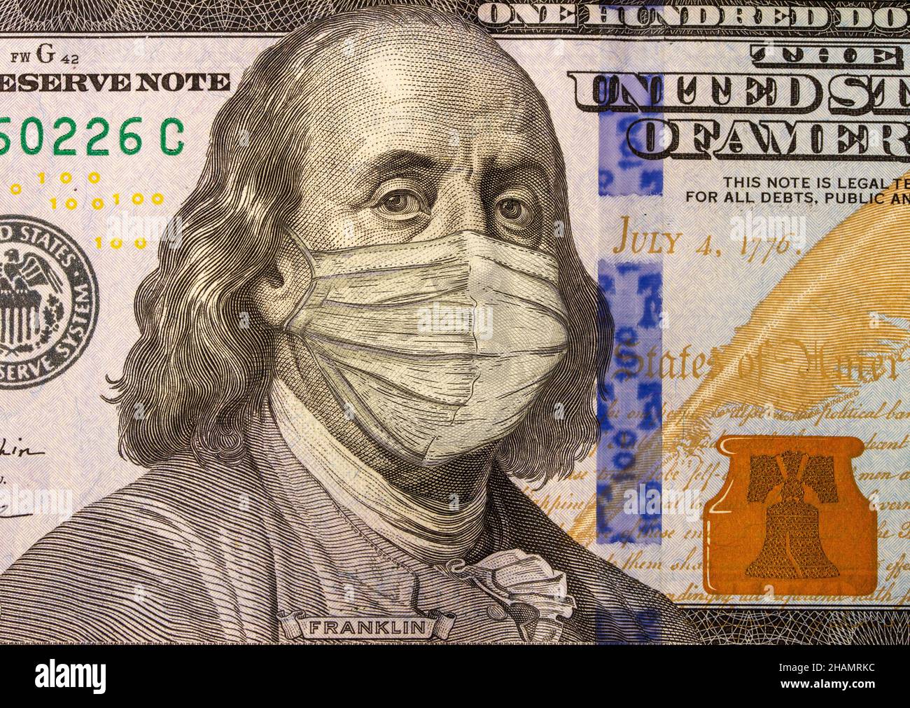 Close up of American hundred dollar bill and Benjamin Franklin wearing a medical mask stylized as an engraving Stock Photo