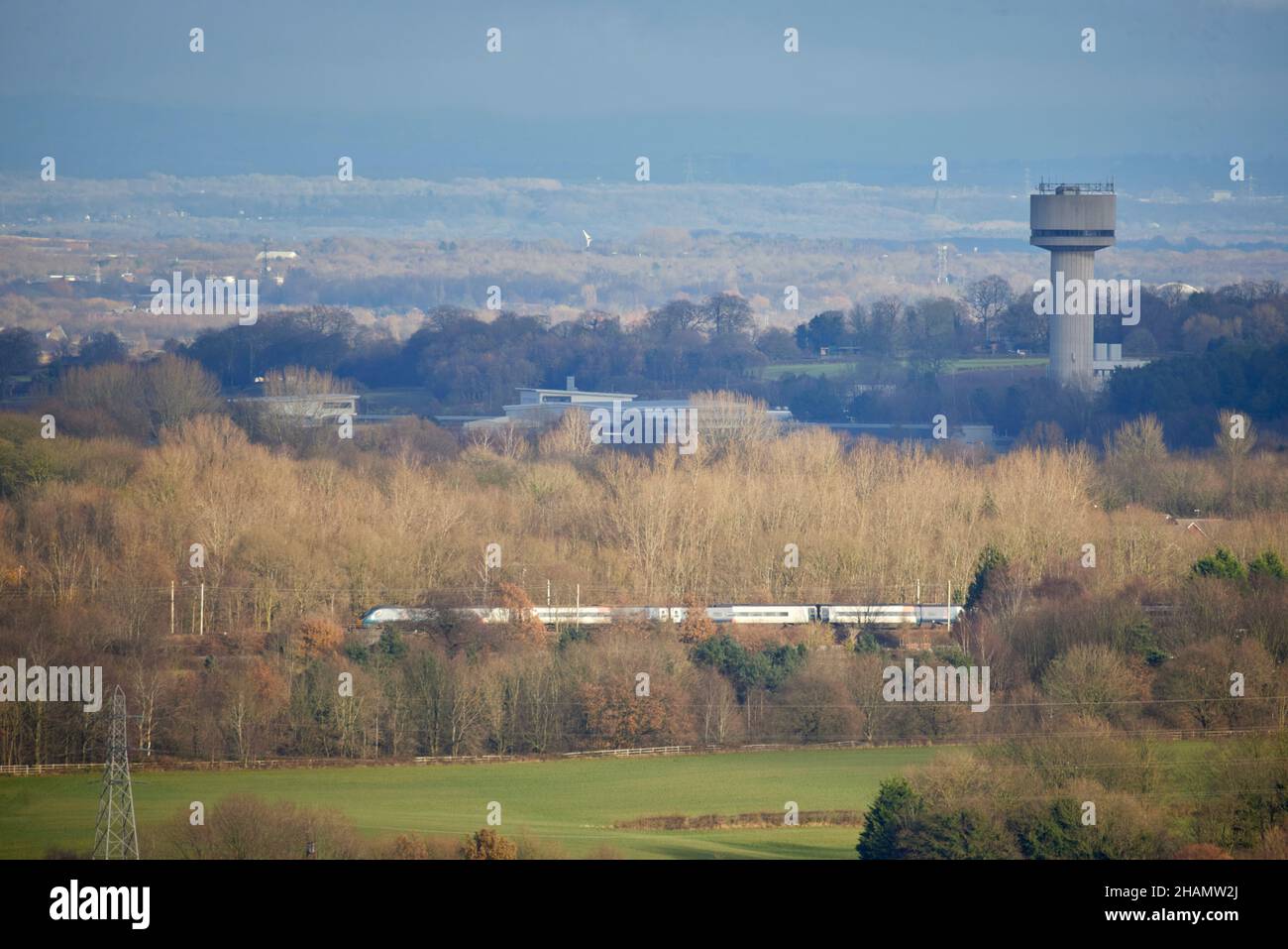 Daresbury Laboratory, Nuclear Structure Facility with a London to Liverpool WCML train passing Stock Photo