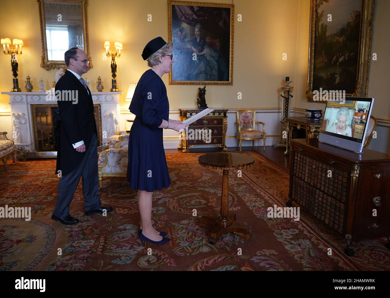 Queen Elizabeth II appears on a screen via videolink from Windsor Castle, where she is in residence, during a virtual audience to receive Mikaela Kumlin Granit, the Ambassador from the Kingdom of Sweden, and her husband Jakob Granit, at Buckingham Palace, London. Picture date: Tuesday December 14, 2021. Stock Photo